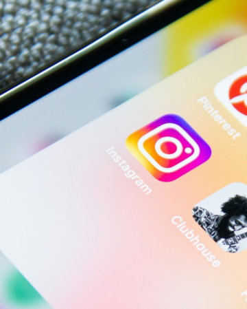Social media app icons on a smartphone screen with a textured grey background