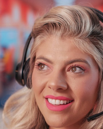 a woman wearing headphones and smiling at the camera